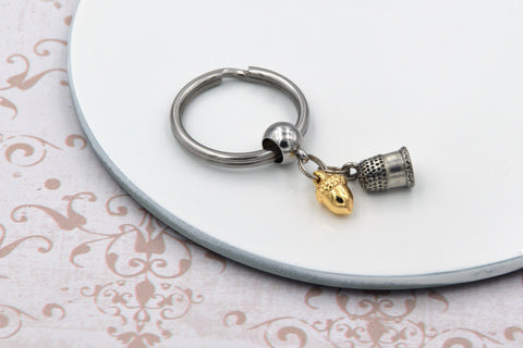Peter Pan Kiss Keychain with Thimble and Acorn Charms fripparie